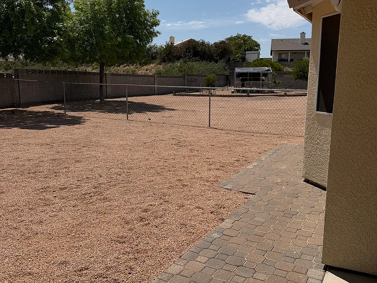 Existing chicken coop and established fruit trees in separately fenced side yard.