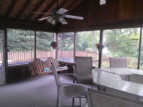 large screen room with new outdoor carpet leading to large pool deck
