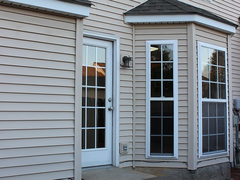 Back door to property into a private fenced in courtyard area