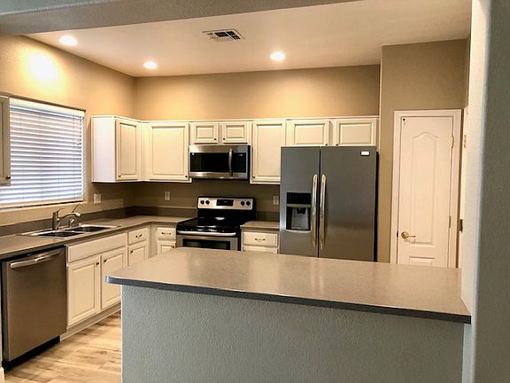 open kitchen with stainless steel appliances and granite counters