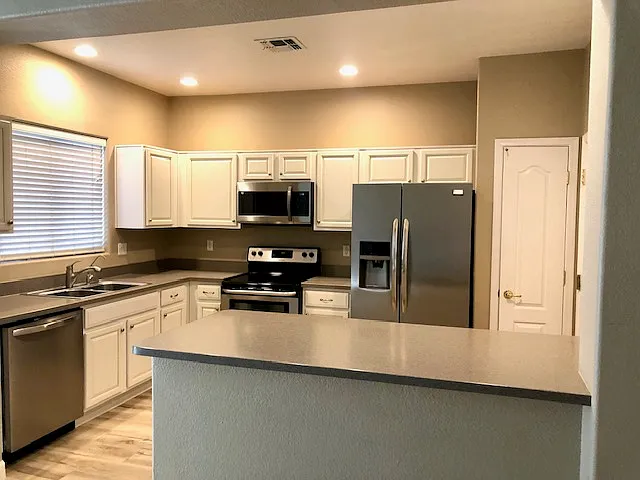 open kitchen with stainless steel appliances and granite counters