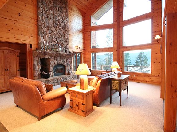 Great room with floor to ceiling, wood-burning fireplace.