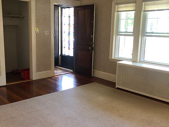 spacious living room with deep coat closet and beam ceilings!