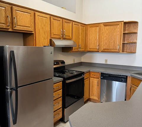 Large kitchen with stainless steel appliances.