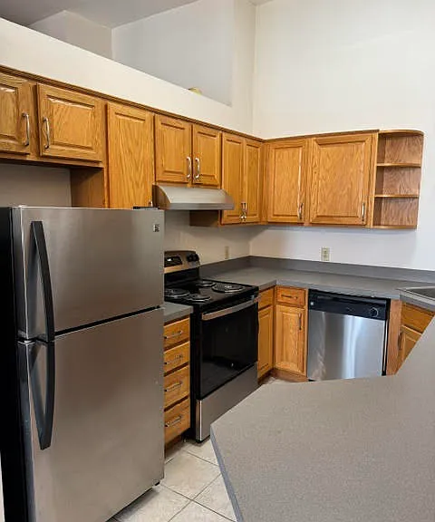 Large kitchen with stainless steel appliances.