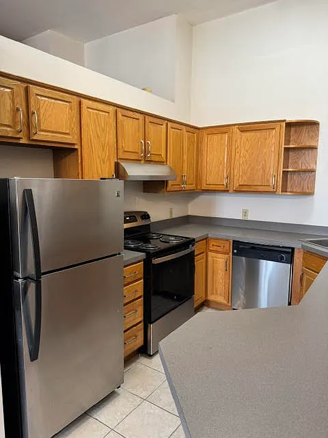 Large kitchen with stainless steel appliances.