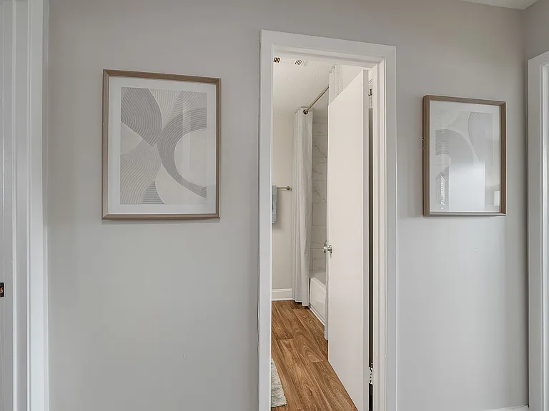 Hallway with hardwood-style flooring & great wall space