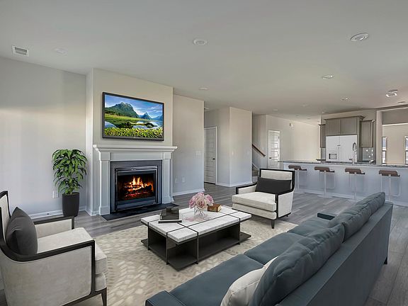 This Great Room Space adjacent to the upgraded kitchen is a lovely family room for entertainment. Additional family room upstairs for more personal space.