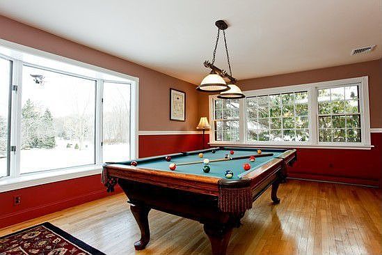 Formal living room being used for billards. Phenominal window overlooking yard