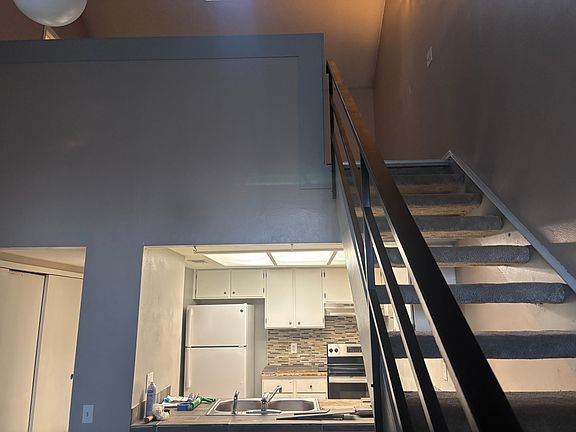 Kitchen & stairs leading to loft.