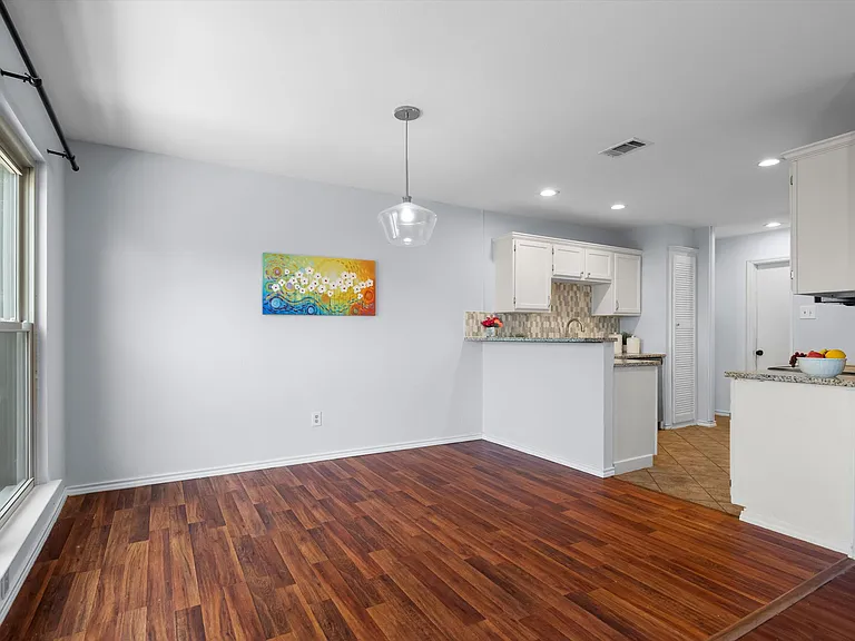 The dining area is open to both the kitchen and the living room.