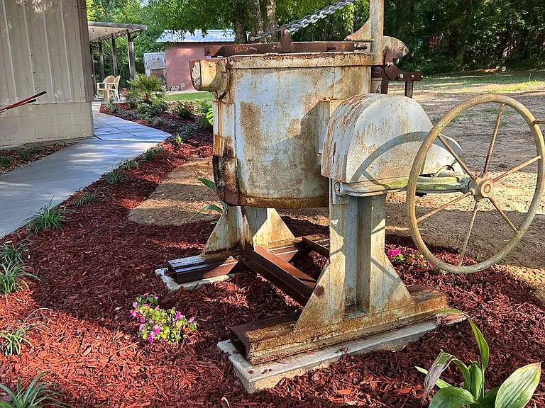Foundry furnace static display in front of parking area.