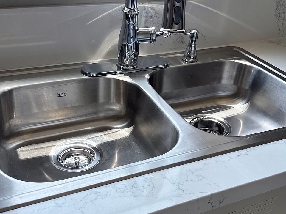 New quartz counter top, double stainless steel sink, and pull down faucet