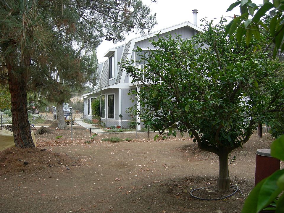 Looking south from citrus grove to front entry. Faces circle drive  inside fro
