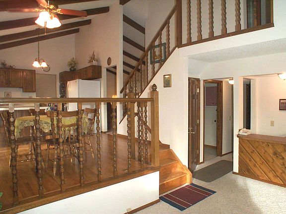 Open floor plan with vaulted ceilings and refinshed hardwood floors