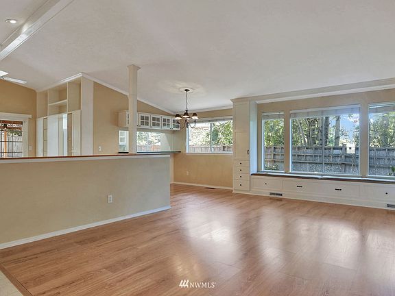 Vaulted greatroom entry. That half wall is not structural or load baring, purely decorative and added by the owner. >