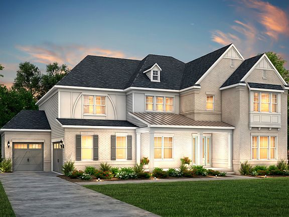 Fearington Exterior 15 features brick, hardie siding, covered front porch and 3 car sideload garage