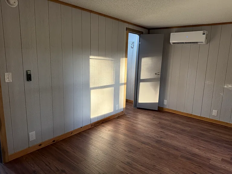 Bedroom 3 with bay window the front yard, its own mini split HVAC and lighted closet.