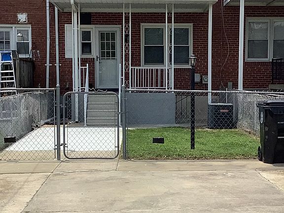 rear yard with parking pad and covered porch fenced yard