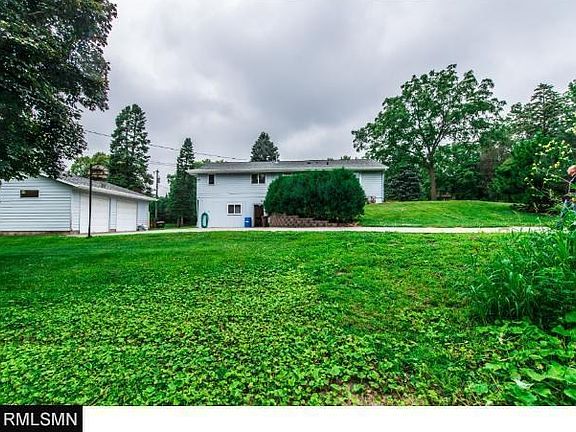 This view shows the lower home entrance. This entrance is to an additional work/hobby room. Look close at the lower 2 windows area, this was once where there was a 2 car garage. This wall is easily moved to bring in large projects to the work room!