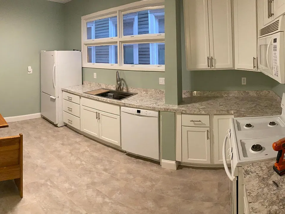 Panoramic of the Kitchen. New Cabinets and Counter tops, Sink, Garbage disposal and Dishwasher. Built In Microwave above the Stove and Fridge