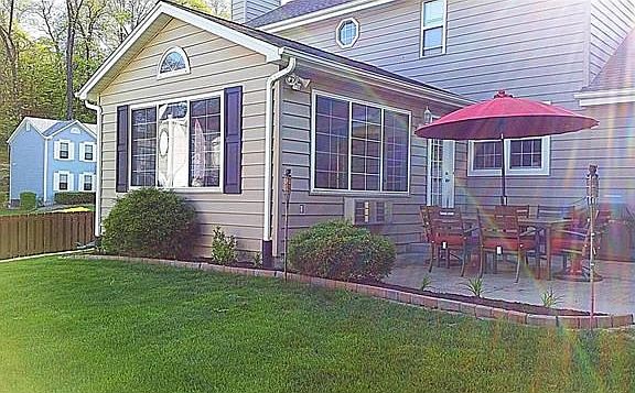 Enjoy the outdoor beauty from the private patio overlooking a level fenced yard. Notice the room addition of the vaulted sunroom.