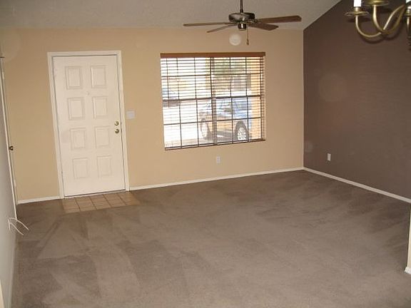 Living room with vaulted ceiling, fan