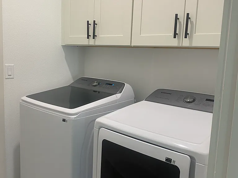 Washer and dryer off the kitchen with access to the garage