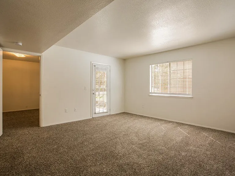 Living room area with tall ceilings and patio access