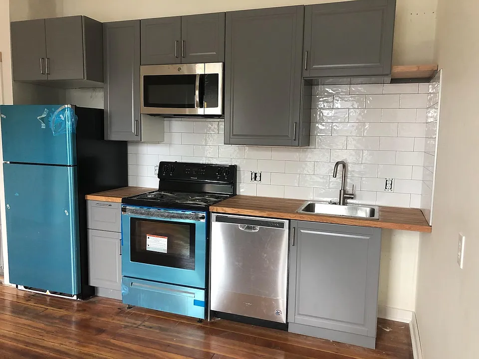 Beautiful, fully renovated kitchens with stainless steel appliances. The blue is only a protective covering as they are brand new. Backsplash is not glossy, just caught the light in this picture.