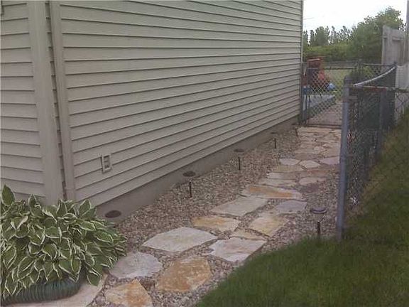 Side yard, beautiful stone walkway along side of house.