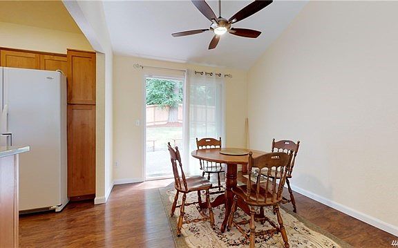 Dining area with sliders that lead to a large backyard.