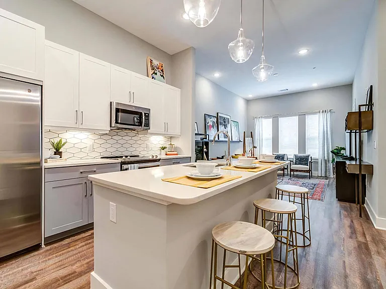 Spacious Kitchen with Island Seating, Stainless Steel Appliances, and Wood-Style Floors