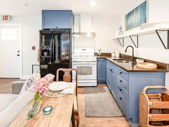 Kitchen with major refrigerator, stove/oven, microwave, toaster, and coffee maker
