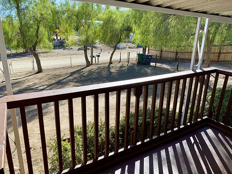 View from front deck of yard and trees.