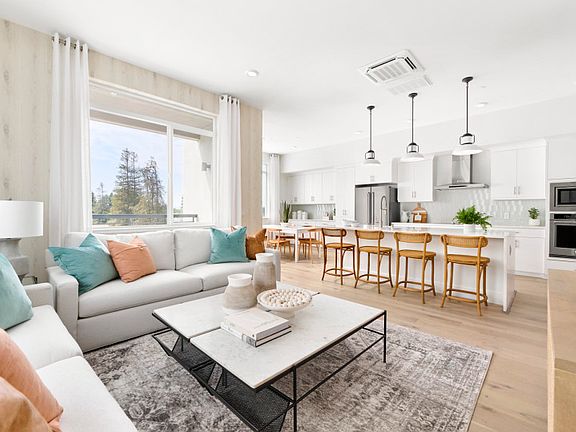 Open-concept gathering area with view of kitchen