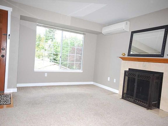 Living room has fireplace with an attractive Travertine surr