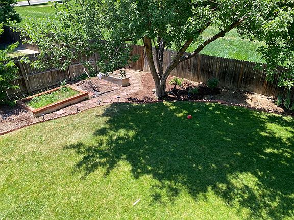 Shaded, fenced back yard with 3 garden boxes and irrigation system. Back gate accesses greenbelt and walking path to Waneka Lake.