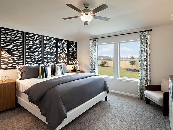 Primary suite is tucked away at the back of the home, a true sanctuary.