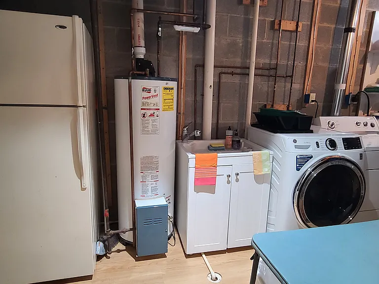 Separate room with Full size refrigerator, kitchen sink, full size washer and dryer. Houses the utility room. Access to this would be shared with owner as needed.