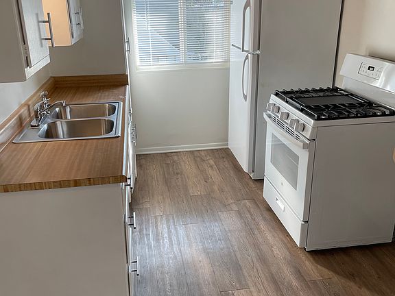 Galley kitchen with new gas range and oven.