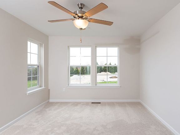 Owner s suite with lots of windows and beige walls