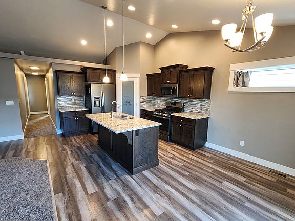 Modern lighting that enhances a bright, welcoming space ideal for cooking, dining, and gathering.