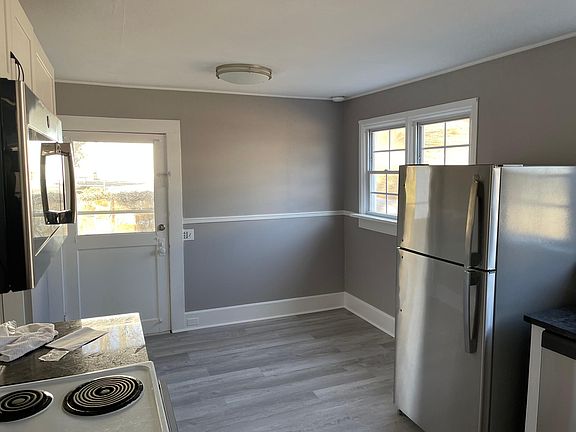 Kitchen with view of door to back patio area