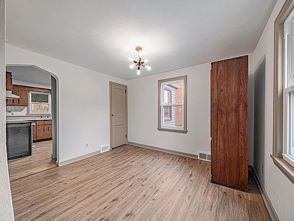 Bright and spacious dining room with updated light fixture perfect for family dinners!