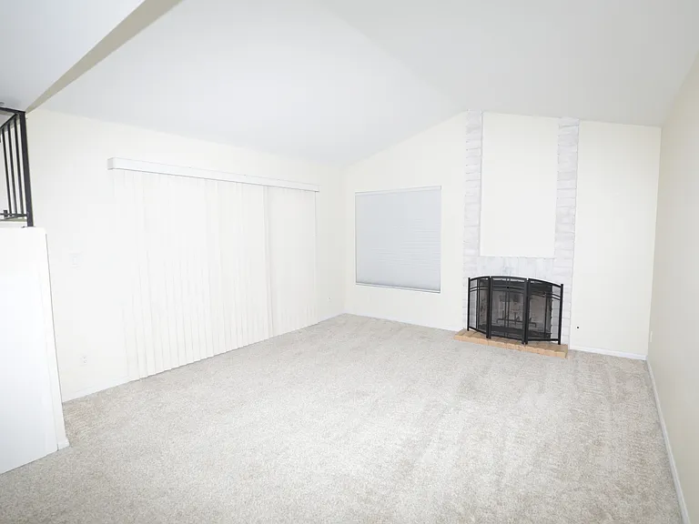 Living room with fireplace and sliding door access to outside patio