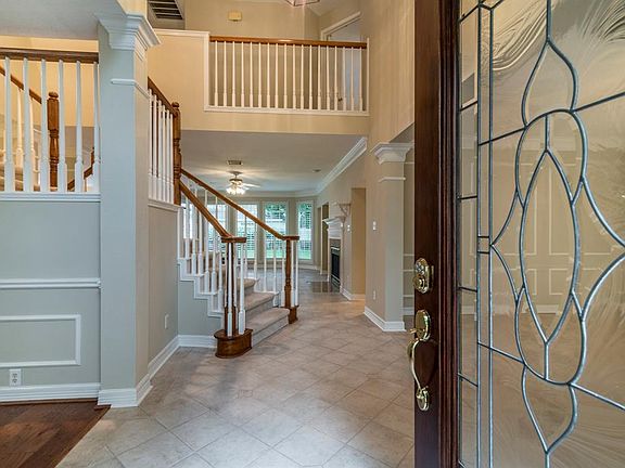 Large, inviting entry with leaded glass front doors. Dining room to the right and living room to the left.