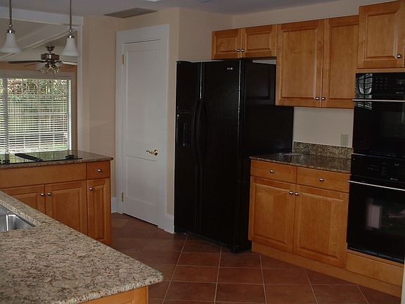 New kitchen with granite and wood cabinets