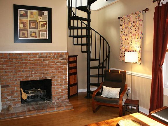 Cool spiral stairs lead you up to 2 more bedrooms w/private balcony.