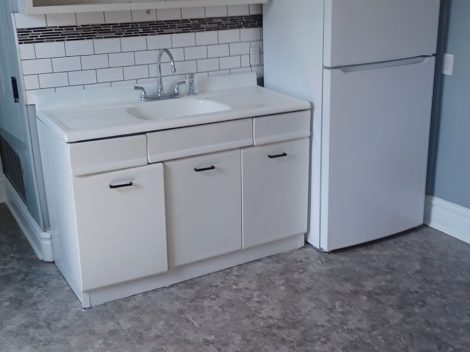 Original metal cabinets and sink.